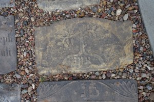 A stone with a tree with a broken branch, which became the logo for the lapidarium in Wronki