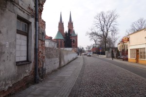 A wall stands where 15 Tumska Street used to be. The cathedral is in the background.